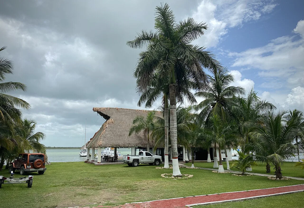 Thatched palapa and palms at a marina in Bacalar.