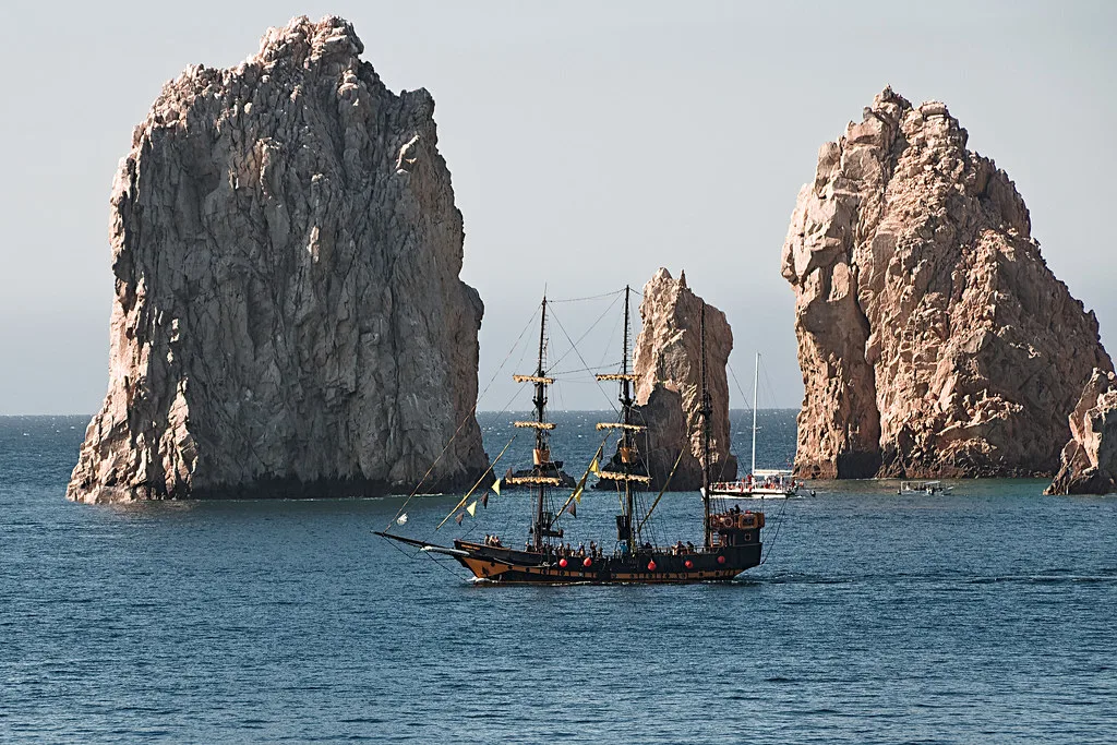 Pirate ship sailing past the rock pinnacles at Land's End, Cabo San Lucas.