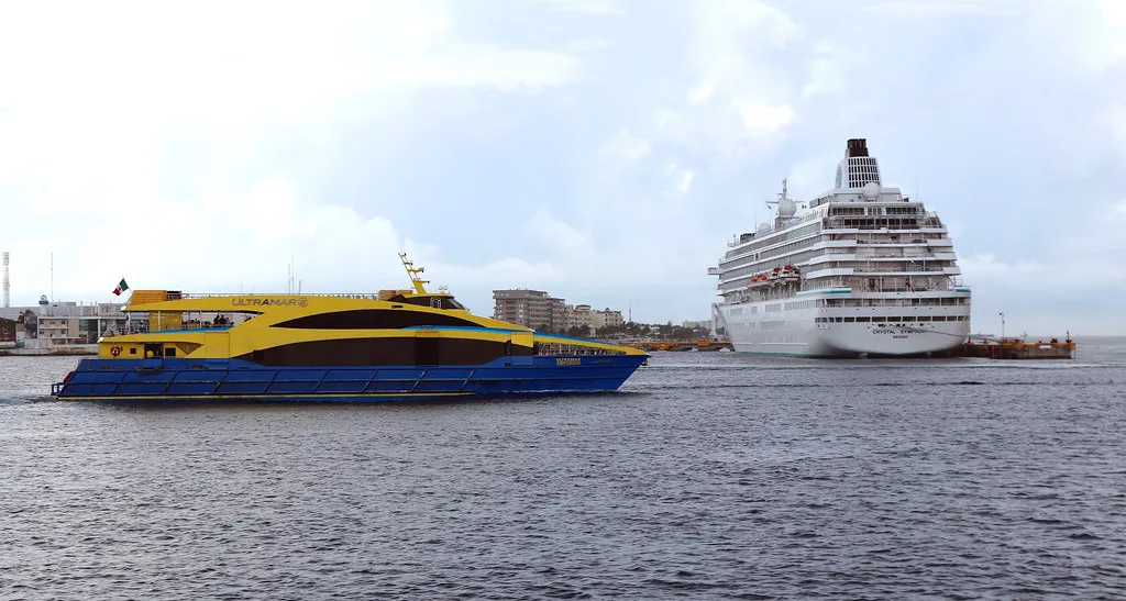 Ultramar ferry and a cruise ship off the Cozumel waterfront.