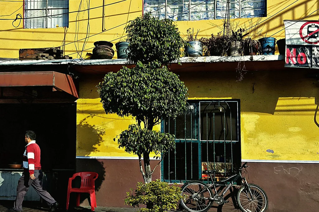 Bright yellow storefront on a Mexico City street.