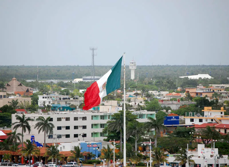 Mexican flag above the rooftops of San Miguel on Cozumel.