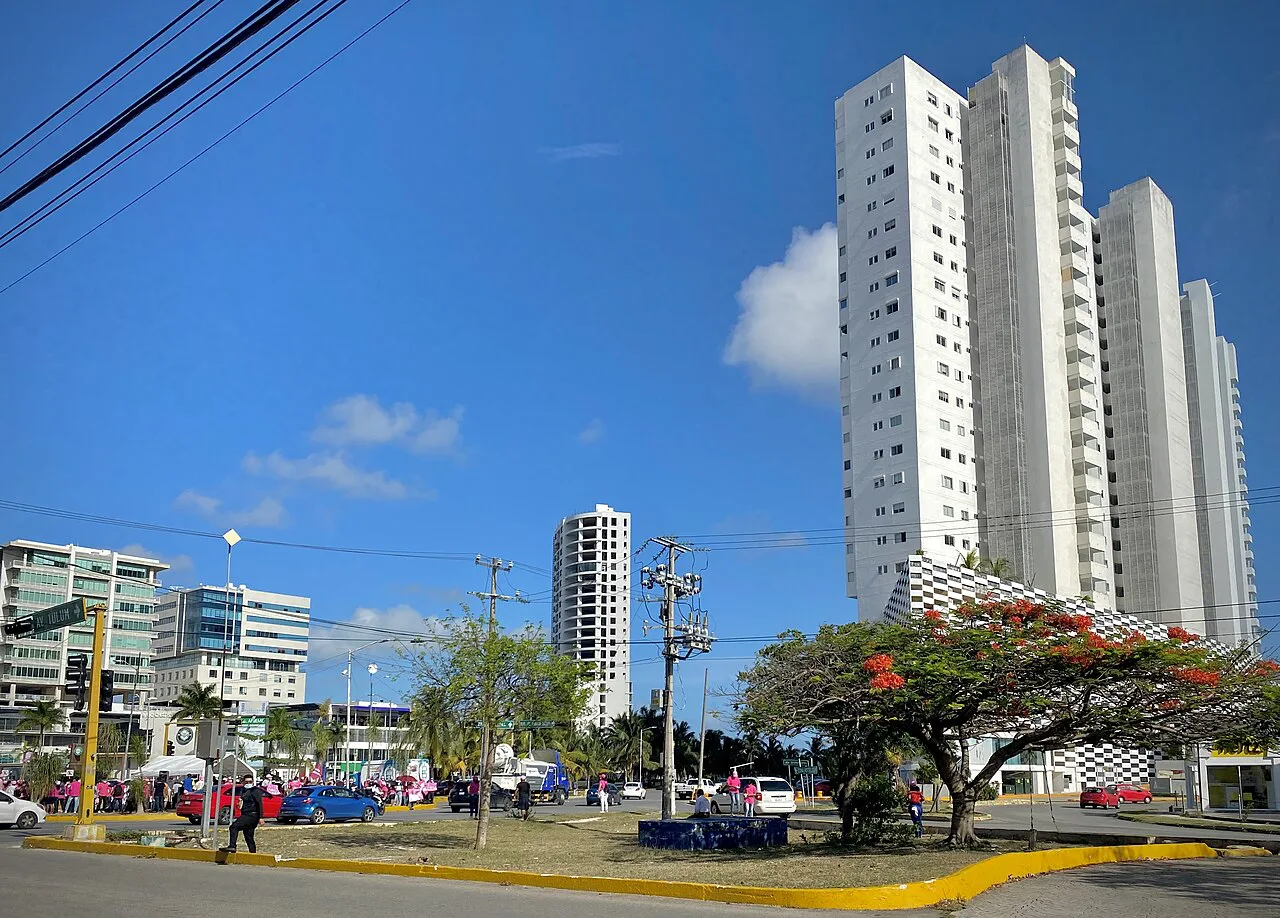 High-rise towers under a blue sky in Cancún.