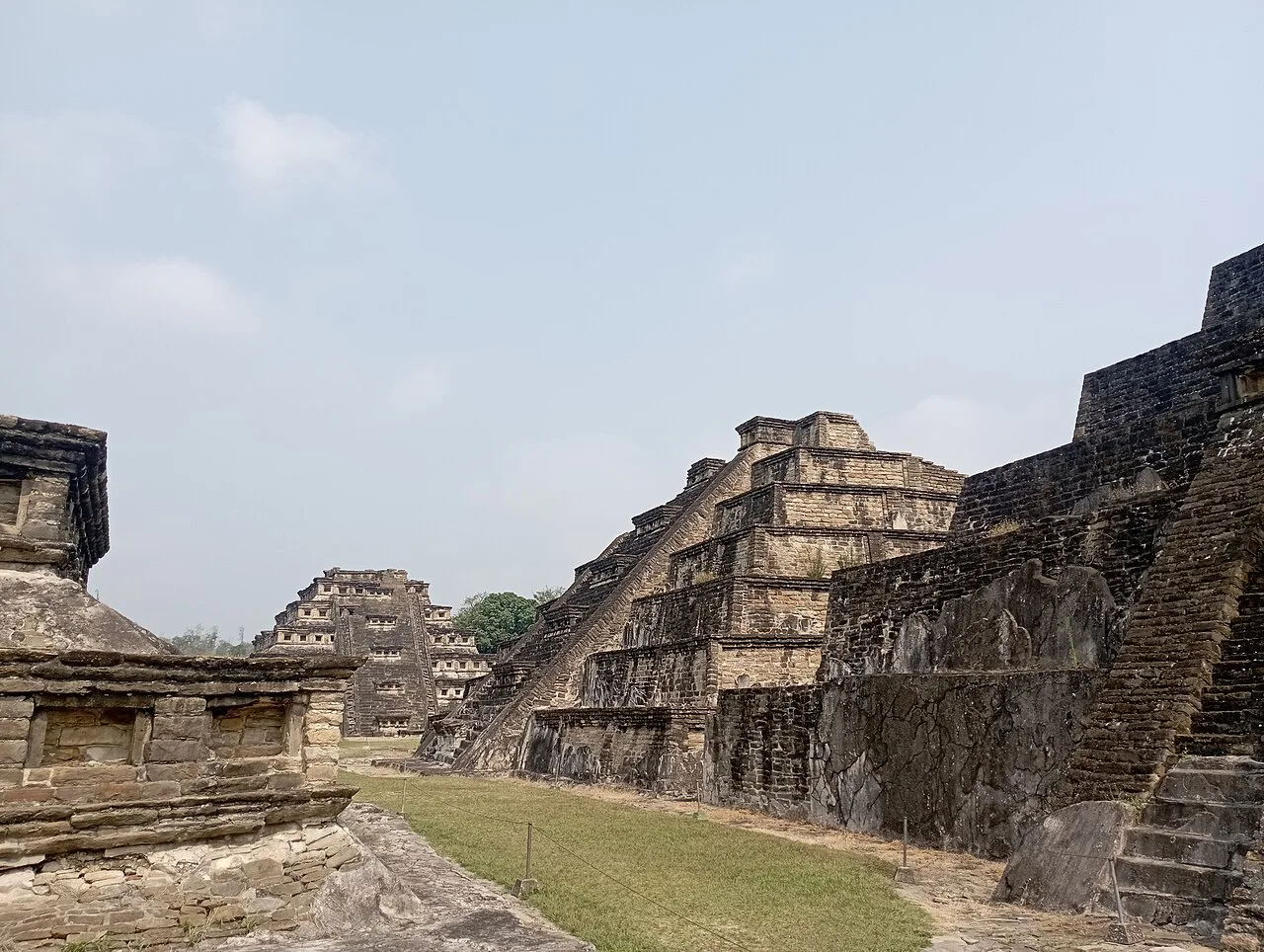 Stepped pyramids around a grassy plaza at El Tajín, Veracruz.