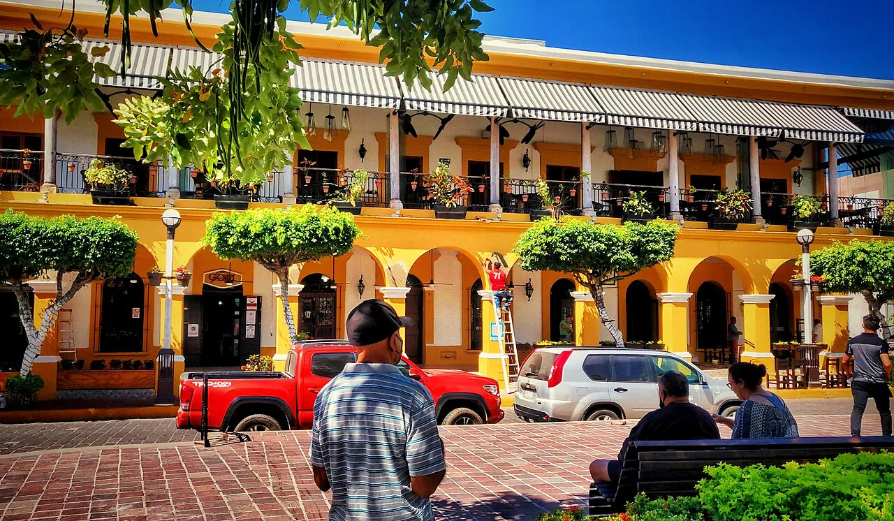 Yellow colonial building with balconies in Mazatlán's historic center.