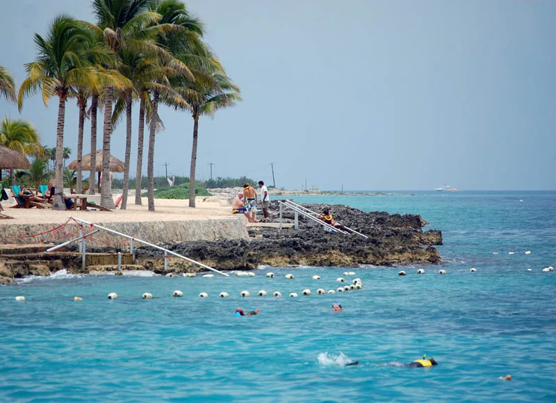 Palm-shaded shore and turquoise water at Chankanaab Park, Cozumel.