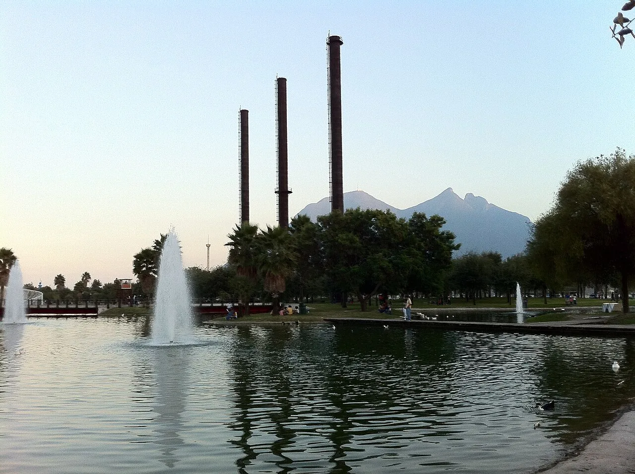 Old foundry smokestacks and a fountain in Parque Fundidora, Monterrey.