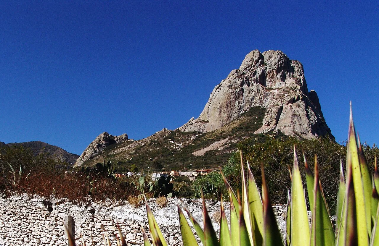 Peña de Bernal seen from the old Camino Real, with agave in front.