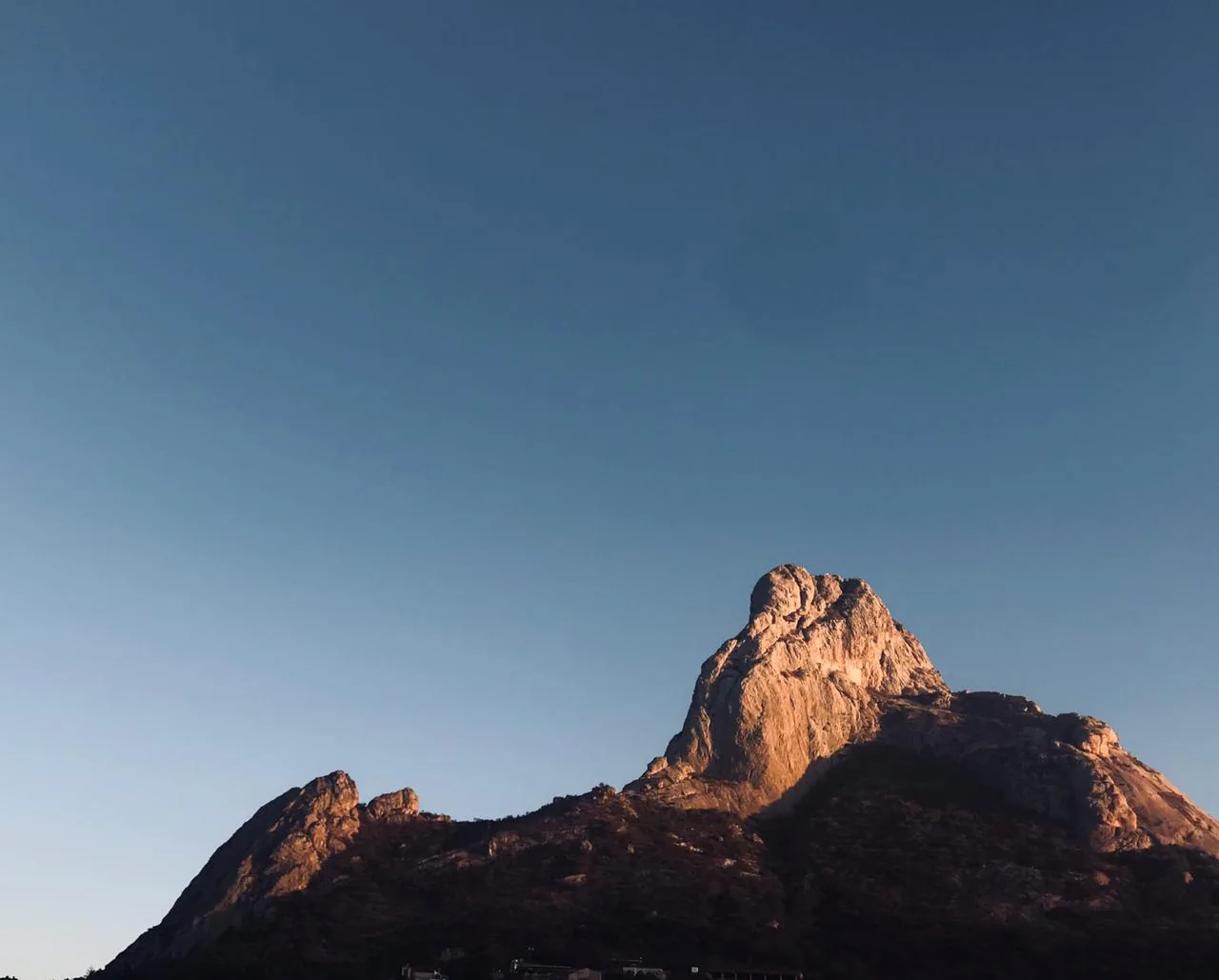 Peña de Bernal at sunrise, seen from the town of Bernal.