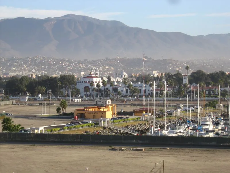 The marina and waterfront in Ensenada, with the hills behind.