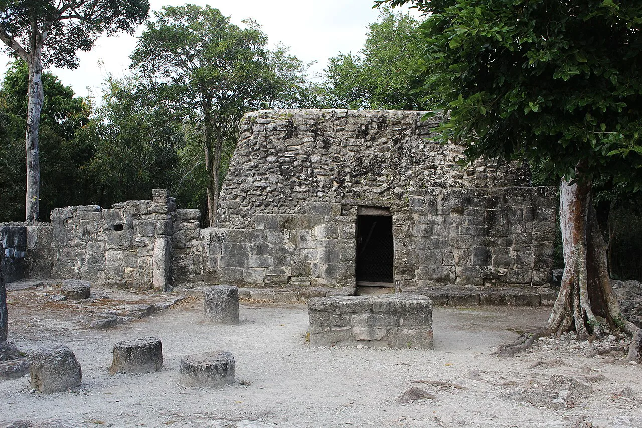 Los Murciélagos structure among trees at San Gervasio, Cozumel.