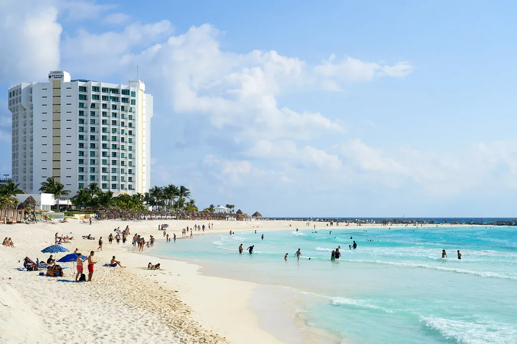 Swimmers on a white-sand beach in Cancún's Hotel Zone.