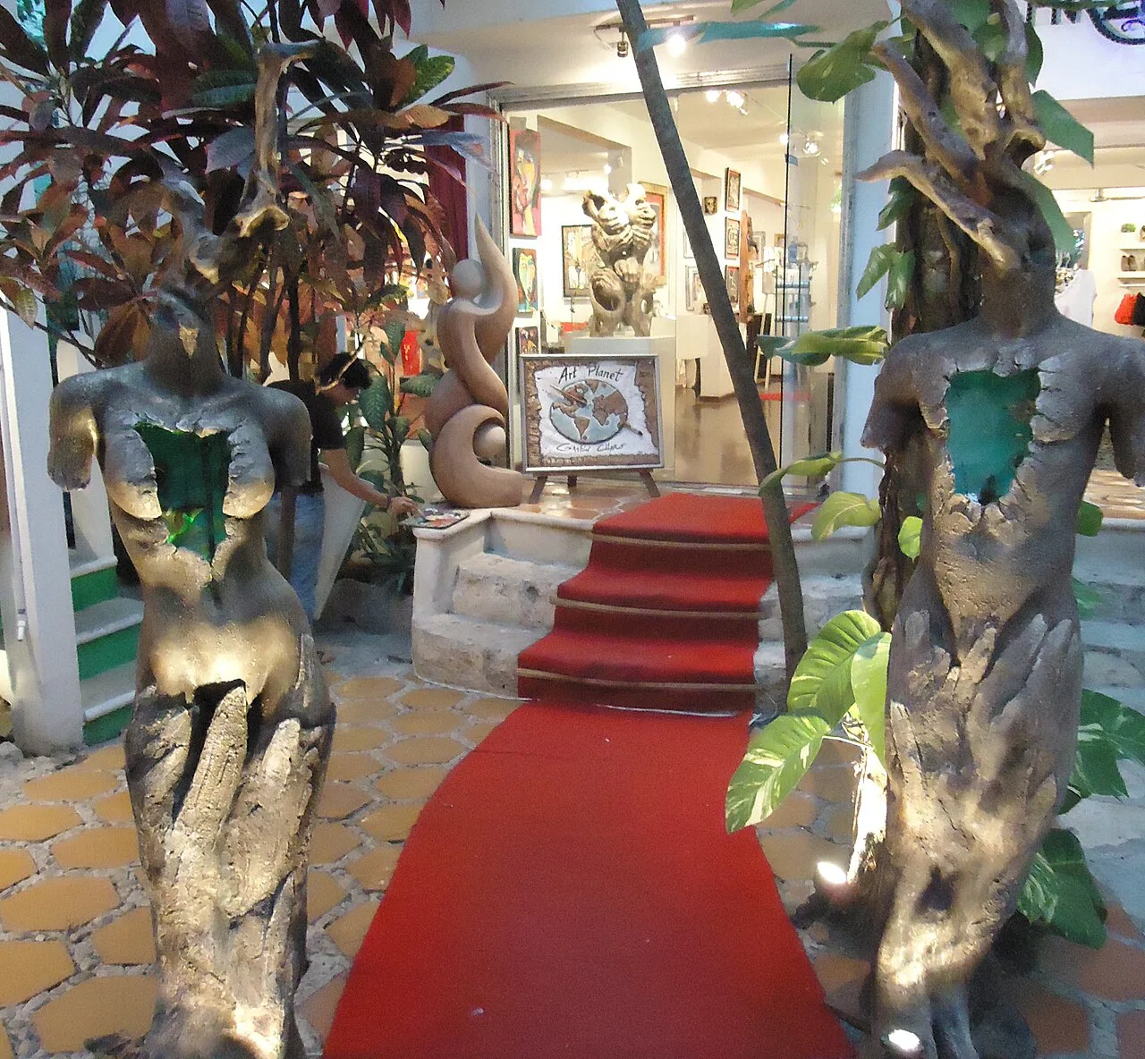 Wooden sculptures at the entrance of an art gallery on Quinta Avenida in Playa del Carmen.