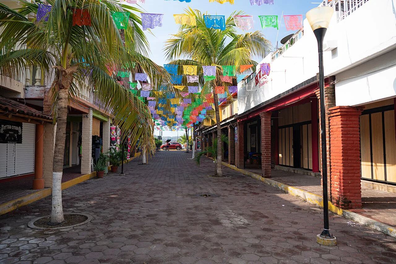 Papel picado over a pedestrian street in Zihuatanejo.